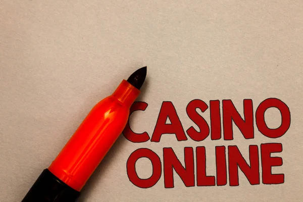 Word writing text Casino Online. Business concept for Computer Poker Game Gamble Royal Bet Lotto High Stakes Open red marker intention communicating message ideas beige background.