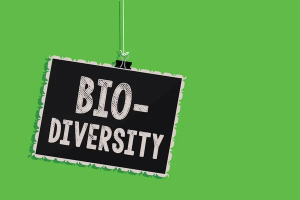 Text sign showing Bio Diversity. Conceptual photo Variety of Life Organisms Marine Fauna Ecosystem Habitat Hanging blackboard message communication information sign green background.