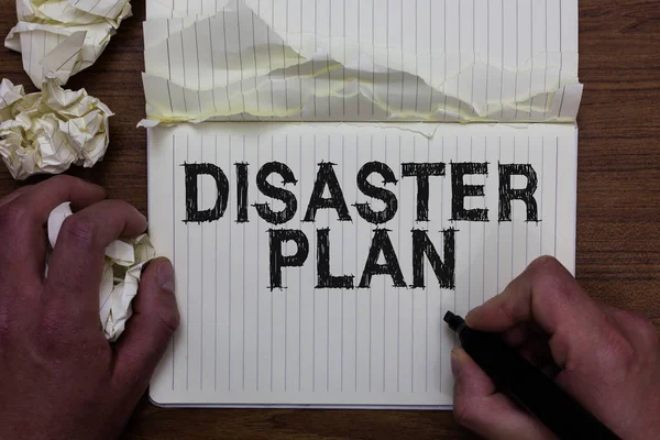 Writing note showing Disaster Plan. Business photo showcasing Respond to Emergency Preparedness Survival and First Aid Kit Man holding marker notebook crumpled papers ripped pages mistakes made.