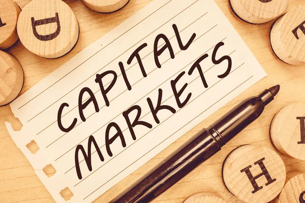 Word writing text Capital Markets. Business concept for Allow businesses to raise funds by providing market security