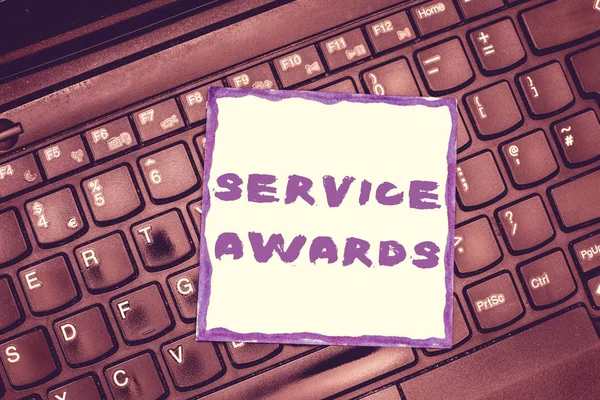 Handwriting text Service Awards. Concept meaning Recognizing an employee for his or her longevity or tenure