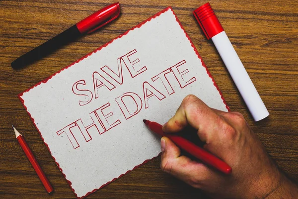 Word writing text Save The Date. Business concept for Systematized events Scheduled activity Recorded Filed Man hand holding marker notebook paper expressing ideas wooden background.
