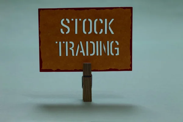 Text sign showing Stock Trading. Conceptual photo Buy and Sell of Securities Electronically on the Exchange Floor Clothespin holding orange paper important communicating message ideas. — Stock Photo, Image