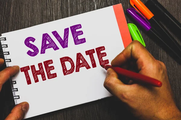 Conceptual hand writing showing Save The Date. Business photo text Systematized events Scheduled activity Recorded Filed Man holding notebook paper communicating ideas Wooden background. — Stock Photo, Image