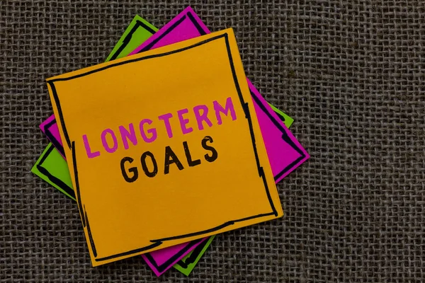 Text sign showing Longterm Goals. Conceptual photo Strategic target that is required more time for completion Paper notes Important reminders Communicate ideas messages Jute background. — Stock Photo, Image