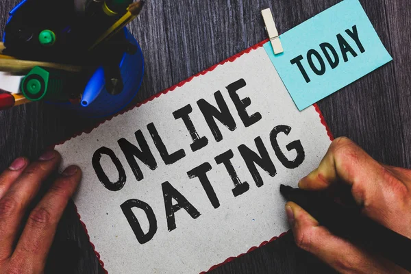 Conceptual hand writing showing Online Dating. Business photo text Searching Matching Relationships eDating Video Chatting Man holding marker paper clothespin reminder cup marker wood table. — Stock Photo, Image