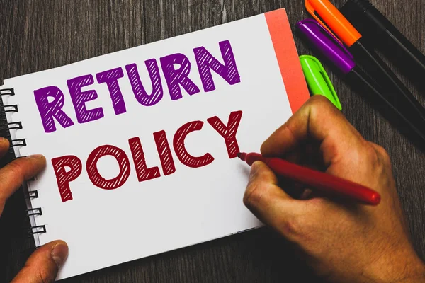 Conceptual hand writing showing Return Policy. Business photo text Tax Reimbursement Retail Terms and Conditions on Purchase Man holding notebook paper communicating ideas Wooden background.