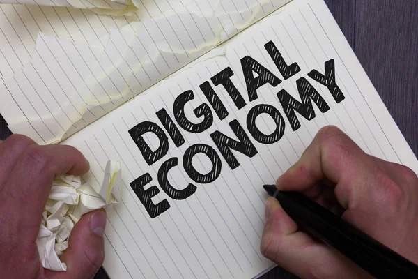 Text sign showing Digital Economy. Conceptual photo refers to one that is based on computing technologies Man holding marker notebook crumpled papers ripped pages mistakes made. — Stock Photo, Image