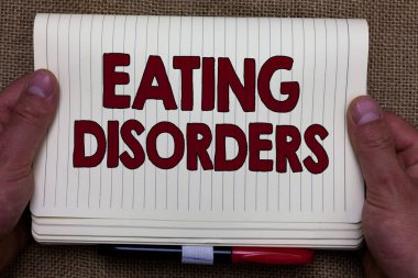 Yeme bozuklukları yazma el yazısı metin. Herhangi bir dizi psikolojik anormal yemek alışkanlıkları bir arka plan Expressing fikirleri not defteri açık sayfa Jüt holding adam eller anlam kavramı.