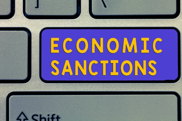 Handwriting text Economic Sanctions. Concept meaning Penalty Punishment levied on another country Trade war