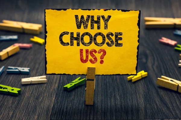 Word writing text Why Choose Us question. Business concept for Reasons for choosing our brand over others arguments Blacky wooden desk laid paper clip randomly one hold yellow board with text.