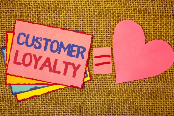 Writing note showing  Customer Loyalty. Business photo showcasing Client Satisfaction Long-Term relation Confidence Pink yellow blue notes black red letters ideas equal sign heart wicker.