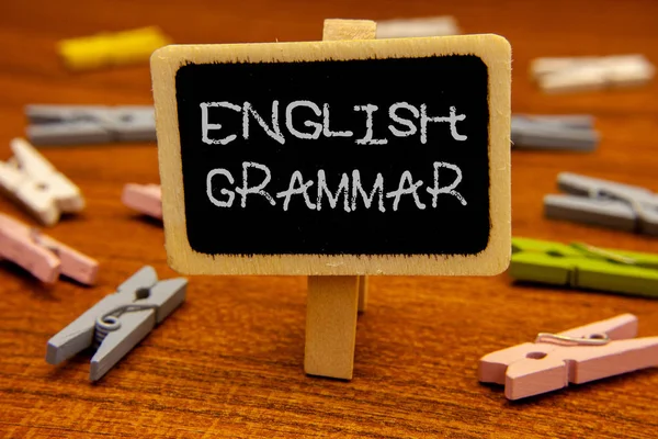 Conceptual hand writing showing English Grammar. Business photo showcasing Language Knowledge School Education Literature Reading Blackboard chalk letters clothespin with wooden background. — Stock Photo, Image
