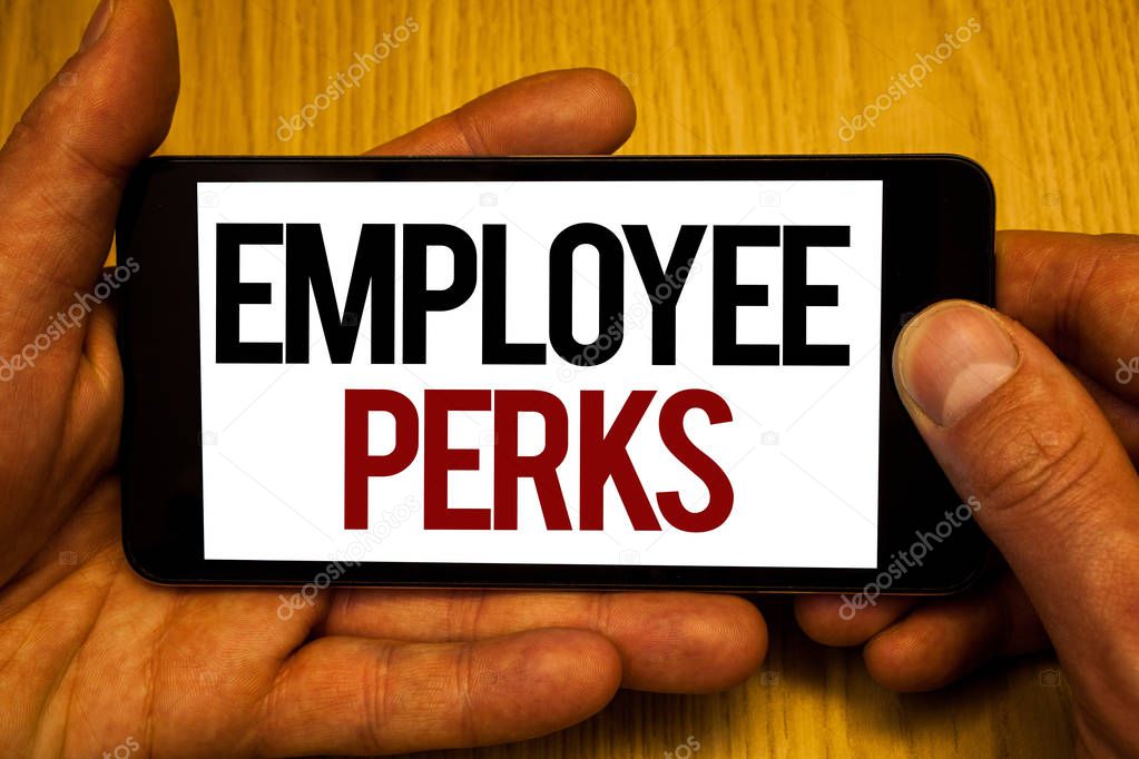 Text sign showing Employee Perks. Conceptual photo Worker Benefits Bonuses Compensation Rewards Health Insurance Two hands holding black phone screen words written home button press.