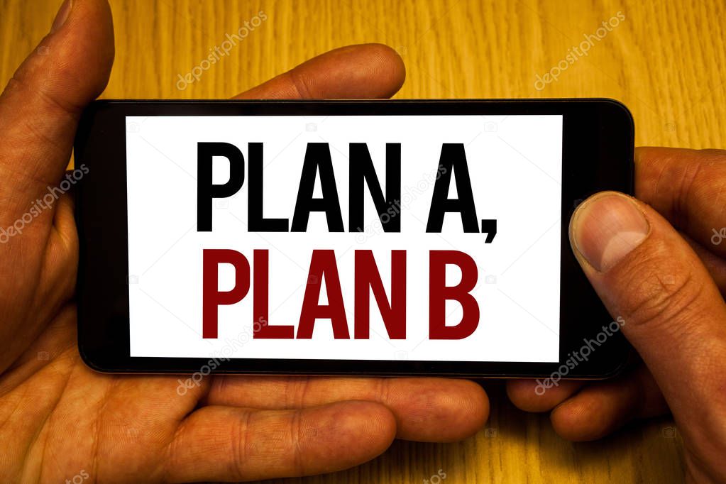 Text sign showing Plan A, Plan B. Conceptual photo Strategic Solutions Ideas Paths to follow to choose from Two hands holding black phone screen words written home button press.