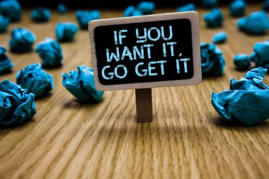 Word writing text If You Want It, Go Get It.. Business concept for Make actions to accomplish your goals wishes Paperclip hold black paperboard with text blue paper lobs on wooden floor. clipart
