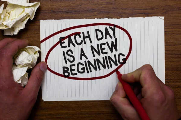 Text sign showing Each Day Is A New Beginning. Conceptual photo Every morning you can start again Inspiration Hand hold paper lob and red pen red circled black words on white paper. — Stock Photo, Image