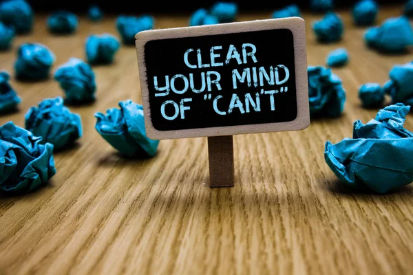 Texte d'écriture Word Clear Your Mind Of Can't not. Concept d'entreprise pour Avoir une attitude positive pensée motivation Paperclip tenir carton noir avec texte lobes en papier bleu sur le sol en bois . — Photo