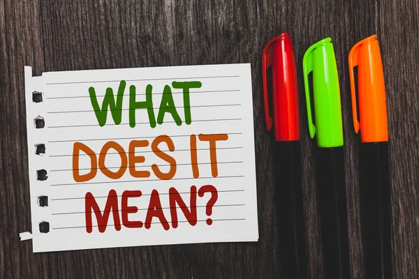 Handwriting text What Does It Mean question. Concept meaning Give me the meaning of something Definition Colorful words with white page red green orange pen on blackish wooden desk. — Stock Photo, Image