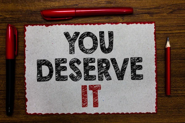 Text sign showing You Deserve It. Conceptual photo Reward for something well done Deserve Recognition award Red bordered white page centered some texts wooden desk pen pencil.