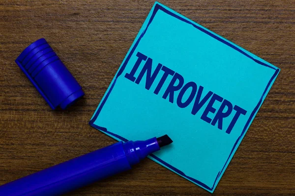 Writing note showing Introvert. Business photo showcasing tend to be inward turning or focused more internal thoughts Blue Paper Important reminder Communicate ideas Wooden background. — Stock Photo, Image