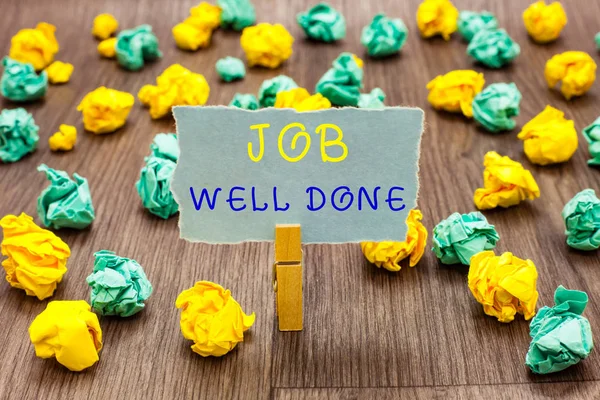Text sign showing Job Well Done. Conceptual photo Well Performed You did it Cheers Approval Par Accomplished Clothespin holding gray note paper crumpled papers several tries mistakes.