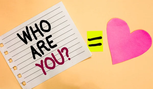 Text sign showing Who Are You question. Conceptual photo Identify yourself description personal characteristics Transverse white paper with words equal love heart on Peach color base. — Stock Photo, Image
