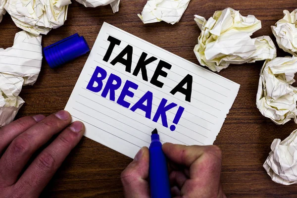 Writing note showing Take A Break. Business photo showcasing Resting Stop doing something recreation time get out of work Hand holding marker write words paper lob scatter around woody desk. — Stock Photo, Image