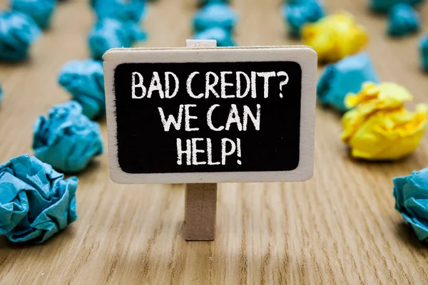 Text sign showing Bad Credit question We Can Help. Conceptual photo Borrower with high risk Debts Financial Paperclip hold written chalkboard behind paper lumps on woody deck.