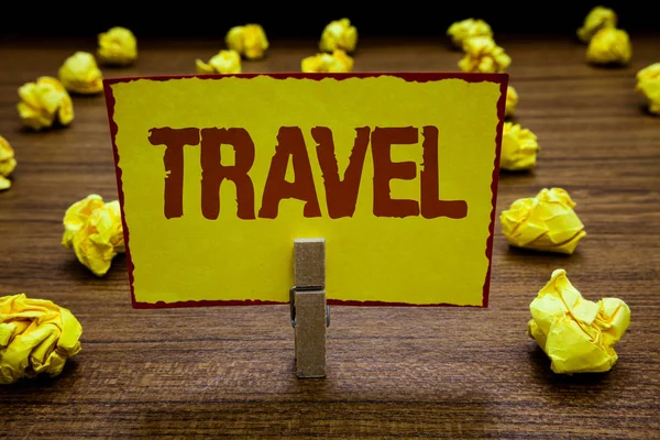Writing note showing Travel. Business photo showcasing make journey typically of some length outside or inside your country Clothespin holding yellow paper note crumpled papers several tries. — Stock Photo, Image