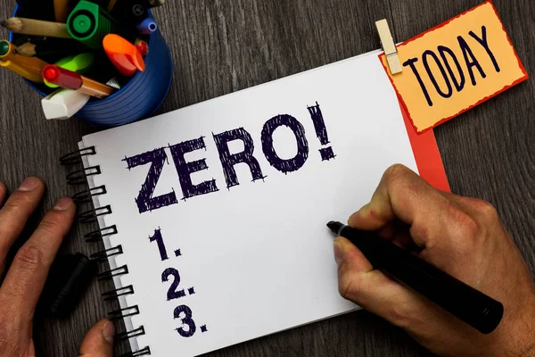 Handwriting text Zero. Concept meaning no quantity or number nought Nothing None Origin point on sketch Man holding marker notebook clothespin hold reminder cup markers wood table. — Stock Photo, Image