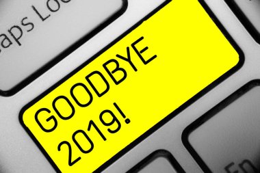 Conceptual hand writing showing Goodbye 2019. Business photo text New Year Eve Milestone Last Month Celebration Transition Keyboard yellow key computer computing reflection document. clipart