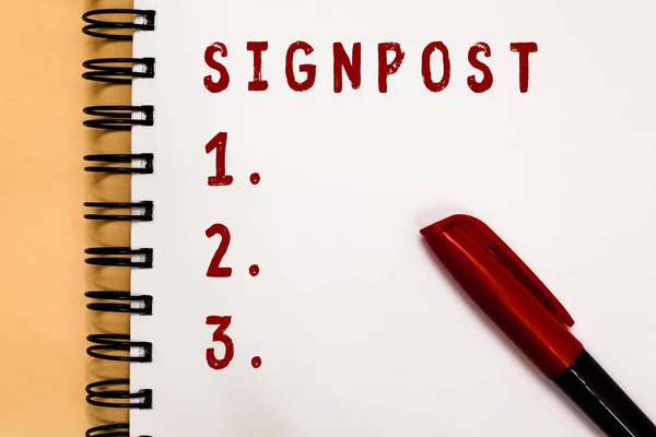 Texto de escritura a mano Signpost. Concepto significado signo dando información tal dirección y distancia ciudad cercana Marcador sobre espiral abierta cuaderno blanco página comunicando ideas mensajes . —  Fotos de Stock