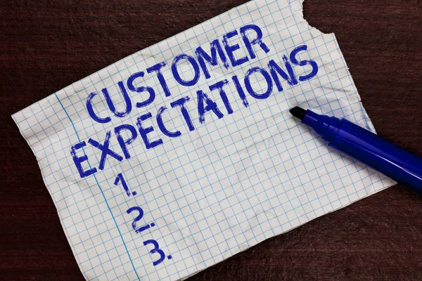 Writing note showing Customer Expectations. Business photo showcasing Benefits a Client Expect Surpass the needs and wants Squared notebook paper Markers Communicating ideas Expressing feelings.