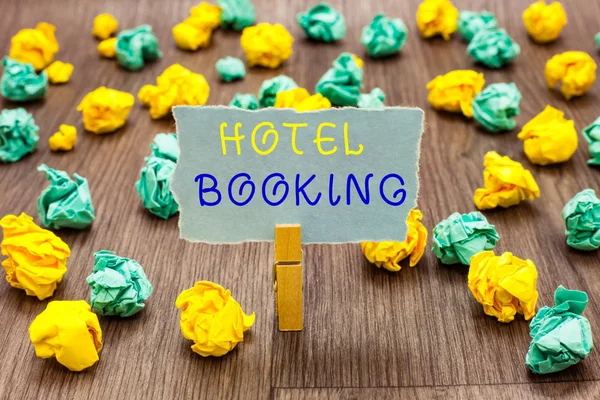 Text sign showing Hotel Booking. Conceptual photo Online Reservations Presidential Suite De Luxe Hospitality Clothespin holding gray note paper crumpled papers several tries mistakes. — Stock Photo, Image