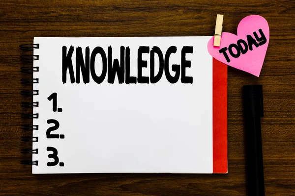 Conceptual hand writing showing Knowledge. Business photo text Facts information skills acquired through experience or education Open notebook page markers holding paper heart wooden background. — Stock Photo, Image