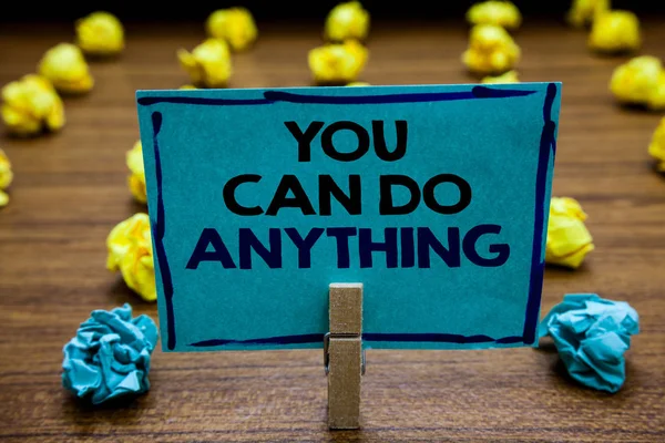 Handwriting text You Can Do Anything. Concept meaning Motivation for doing something Believe in yourself Blurry wooden deck yellow and blue lob on ground paper clip grip page with text. — Stock Photo, Image