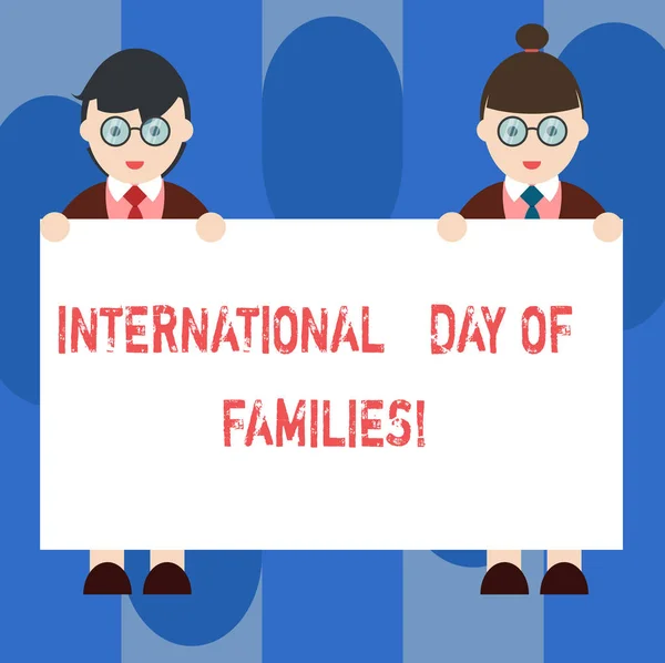 Handwriting text International Day Of Families. Concept meaning Family time togetherness celebration Male and Female in Uniform Standing Holding Blank Placard Banner Text Space.