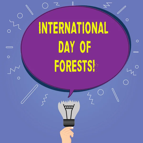 Conceptual hand writing showing International Day Of Forests. Business photo showcasing Natural environment protection celebration Oval Speech Bubble Above a Broken Bulb with Failed Idea icon.