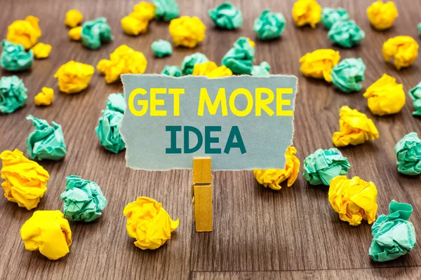 Text sign showing Get More Idea. Conceptual photo Random Input Mind Map Picture Mock up Surveys Visualization Clothespin holding gray note paper crumpled papers several tries mistakes. — Stock Photo, Image