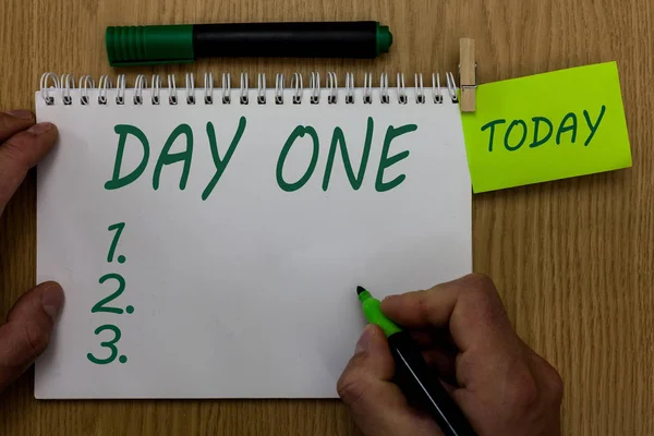 Text sign showing Day One. Conceptual photo Start moment First step Beginning of schedule program event Man holding marker notebook clothespin reminder wooden table cup coffee. — Stock Photo, Image