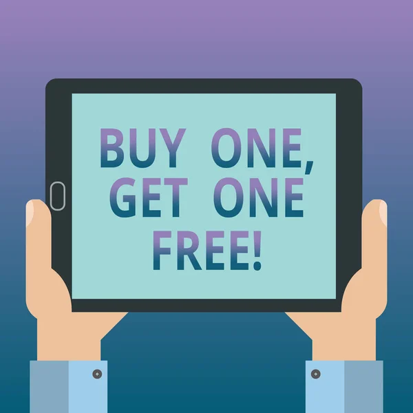 Handwriting text writing Buy One Get One Free. Concept meaning Promotion discount special offering in gift card Hu analysis Hand Holding Blank Screen Tablet Smartphone Display Unit photo.