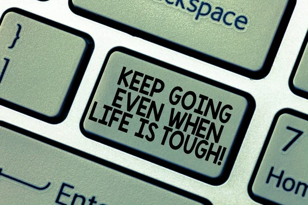 Word writing text Keep Going Even When Life Is Tough. Business concept for Overcome difficulties reach your goals Keyboard key Intention to create computer message pressing keypad idea.