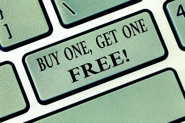 Text sign showing Buy One Get One Free. Conceptual photo Promotion discount special offering in gift card Keyboard key Intention to create computer message, pressing keypad idea.