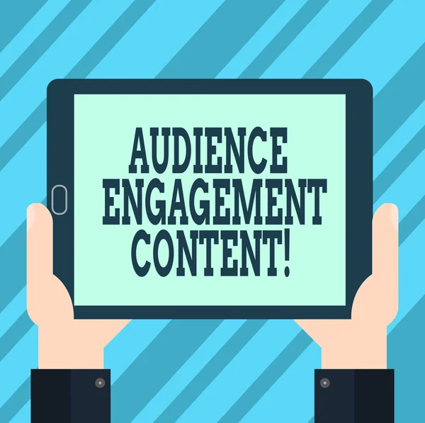 Text sign showing Audience Engagement Content. Conceptual photo Focusing on the wants of the focus audience Hu analysis Hand Holding Blank Screen Tablet Smartphone Display Unit photo.