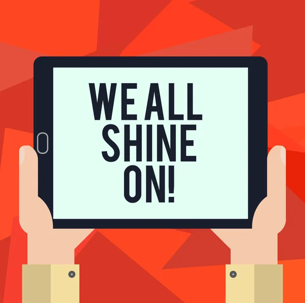 Texto escrito em inglês We All Shine On. Conceito de negócio para todos tem um brilho brilhante Motivational Hu análise mão segurando tela em branco Tablet Smartphone Display Unit foto . — Fotografia de Stock