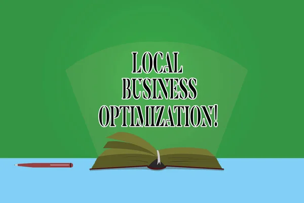 Text sign showing Local Business Optimization. Conceptual photo promote products and services to local customers Color Pages of Open Book photo on Table with Pen and Light Beam Glaring.