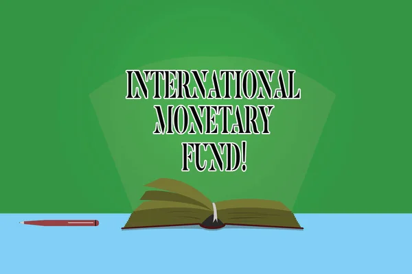 Text sign showing International Monetary Fund. Conceptual photo promotes international financial stability Color Pages of Open Book photo on Table with Pen and Light Beam Glaring.