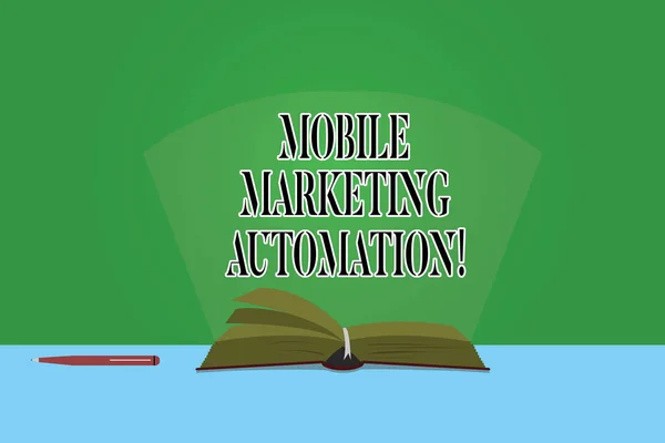 Text sign showing Mobile Marketing Automation. Conceptual photo automate mobile marketing tasks and processes Color Pages of Open Book photo on Table with Pen and Light Beam Glaring.