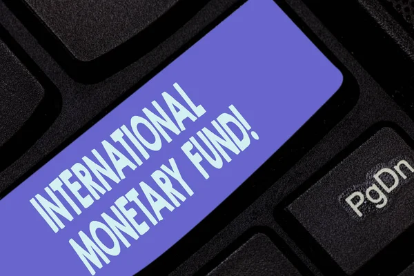 Handwriting text writing International Monetary Fund. Concept meaning promotes international financial stability Keyboard key Intention to create computer message pressing keypad idea.